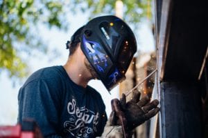 Man welding with protective helmet