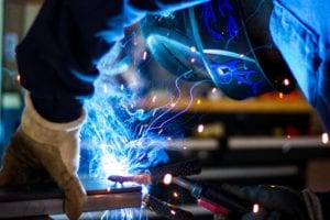 man welding creating welding sparks